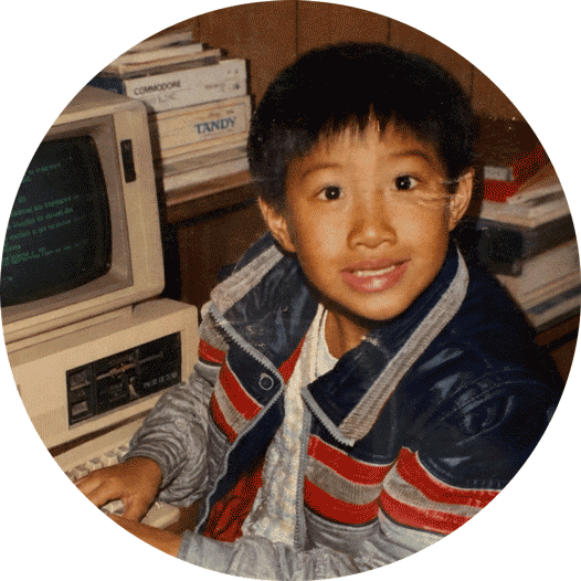 Jose Quan as a child at a Commodore computer.